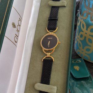 Gucci gold dinner watch with black leather band